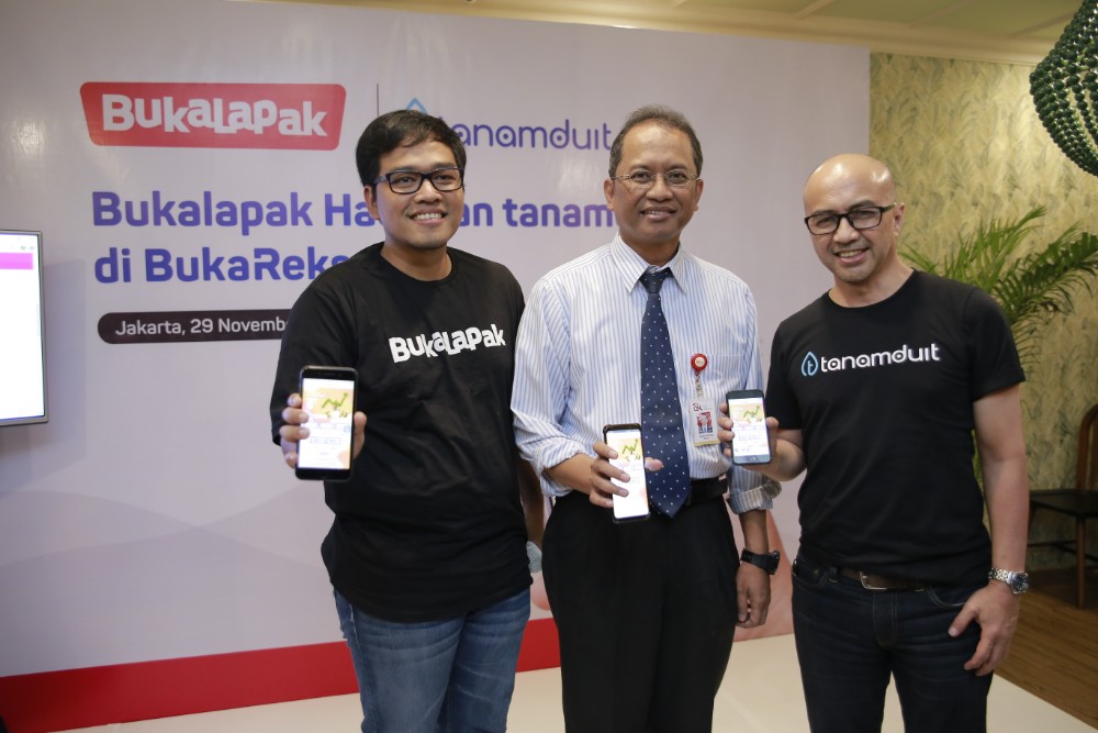 Le-Ri: Destya Danang Pradito (Head of Payment & Financial Service Bukalapak), Halim Haryono (OJK's Investment Management Deputy Director), Muhammad Hanif (Tanamduit's Business Development Director) showing tanamduit feature in Bukalapak app