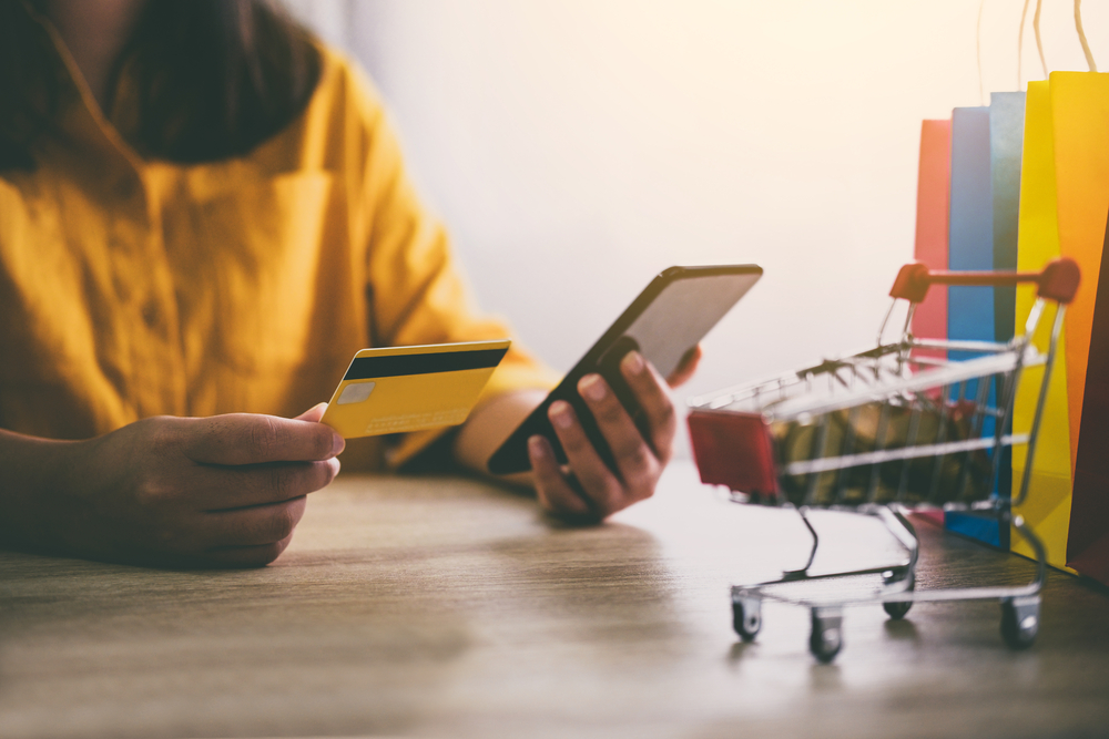 Image of Young woman using smartphone for online shopping websit for SEO