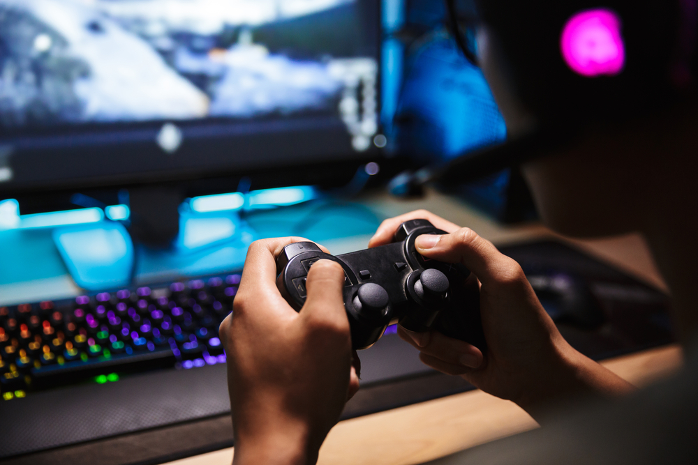 Photo closeup of asian gamer boy playing video games online on c for SEO